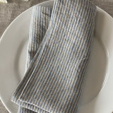 Mīkstināta vidēji plāna lina galda salvetes ar gaiši zilām/dabīgi pelēkām vidēji platām svītriņām un šaurām maliņām