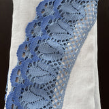 Gaiši zils lina galdauts ar 12cm platu zilu lina mežģīni ar tulpīšu ornamentu